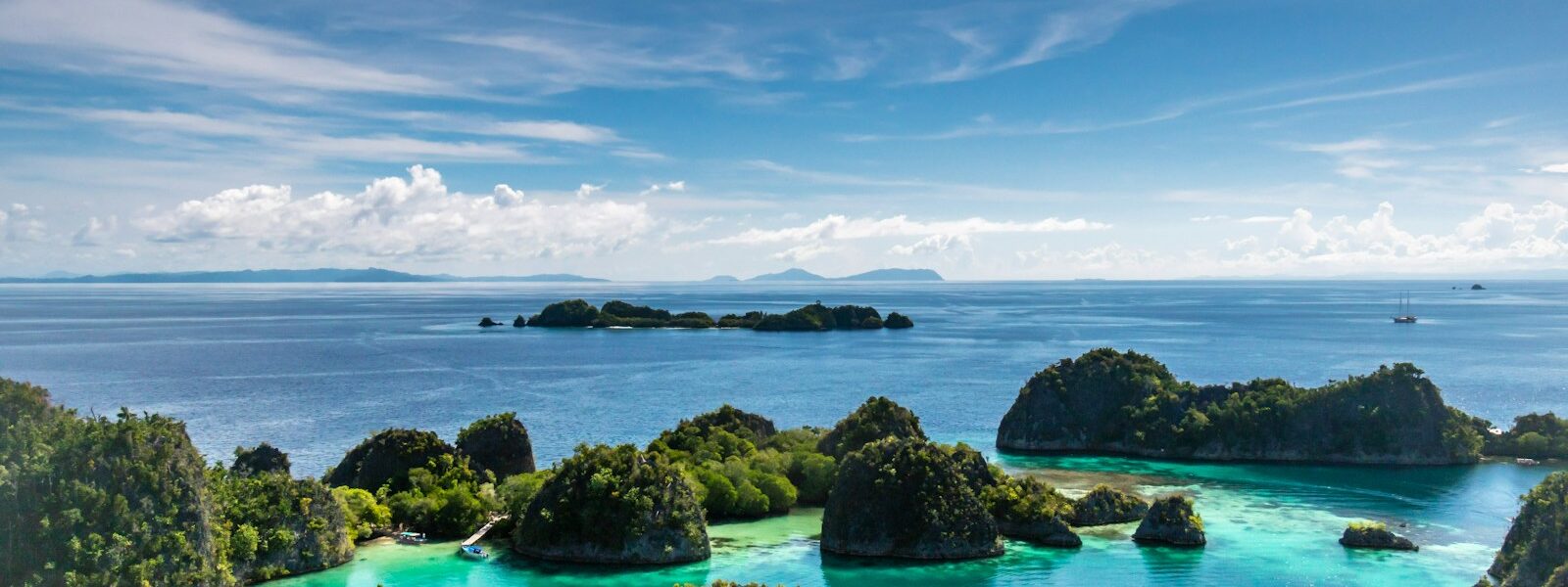 islets surrounded by body of water during daytime