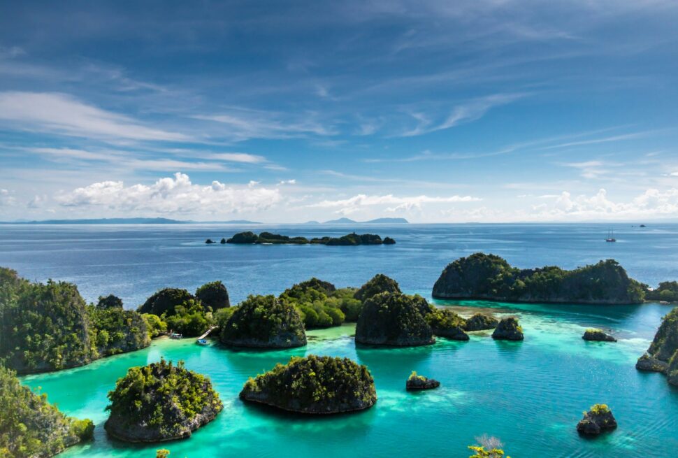 islets surrounded by body of water during daytime