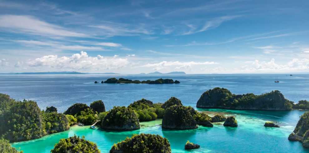 islets surrounded by body of water during daytime