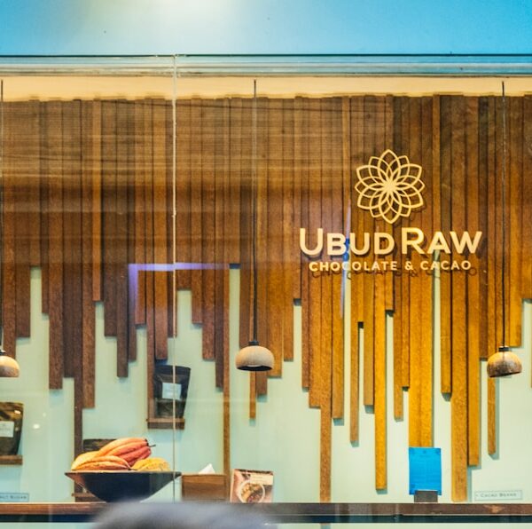 a woman looking at a wall with art on it