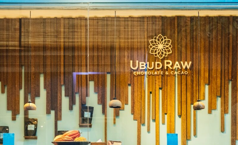 a woman looking at a wall with art on it